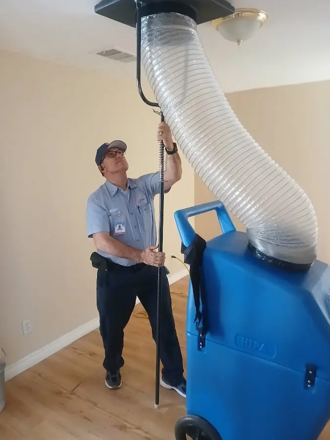 Furnace Tune-Up technician using HEPA equipment in Hendersonville